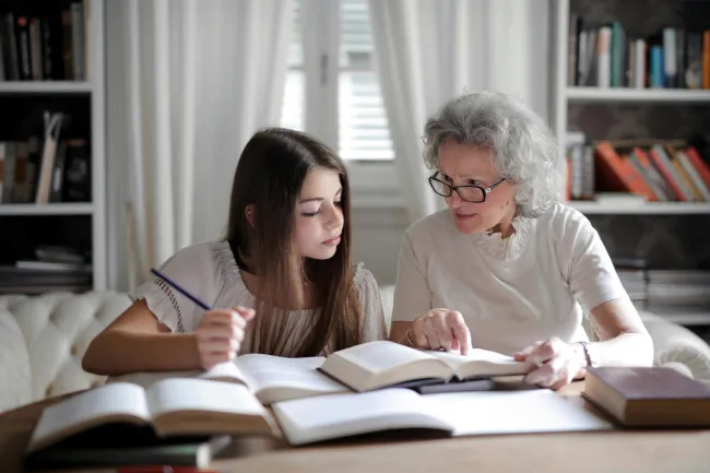 woman teaching girl
